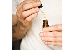 Image Person holding CBD oil.