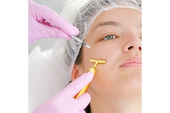Image A woman receives an injectable facial treatment.