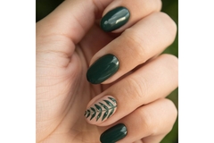 Image Hand with green nail polish.