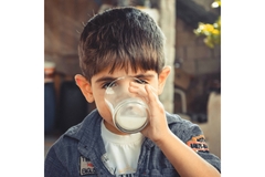 Image child drinking milk from a glass