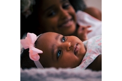 Infant baby girl and her mother being happy