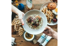Image Plate of food being handed over to someone else
