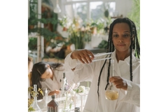 Image Woman in a lab experimenting with botanicals.