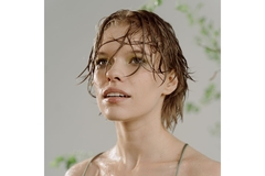 woman with wet hair and face gazing away