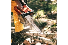 man using a saw hammer to slice a piece of wood