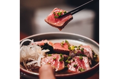 Tuna steak in restaurant eaten with chopsticks