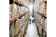 Image warehouse with stacked cardboard boxes wrapped in plastic