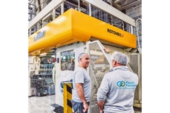 Image CCL Pouch Partners manufacturing unit featuring two employees looking at the machines