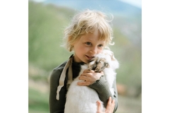 Image Blond boy hugging rabbit on shoulder