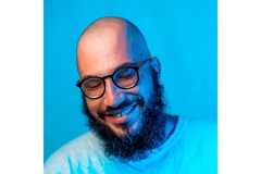 bald man with bear smiling and looking down