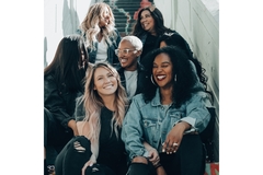 Women from different generations sitting on staircase being happy