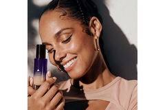 Image Singer Alicia Keys poses with a 2-in-1 Concealer and Tint product by her skin care brand Keys Soulcare.