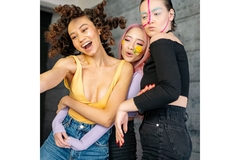 Image Three gen zers wearing colorful makeup and taking a selfie together