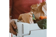 Image Person holding a box of fruits and vegetables.