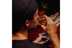 Image Young man drinking glass of whiskey alone