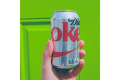 Image hand holding diet Coke.