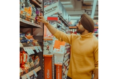 Image Man looking for products in a supermarket.