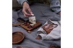 Person eating cheese at a picnic.