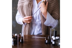 Image woman testing fragrance oils with paper strips.