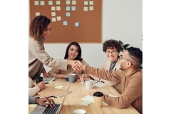 Image People in a business meeting shaking hands.