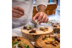 Image Chef plating food on wooden slabs.