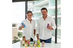 Image Two men holding cans of iced coffee in their hands.
