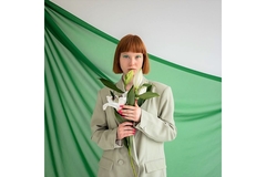 Image Girl holding a bouquet of lilies wearing makeup.