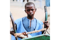 Boy grabbing a wagon and posing at camera