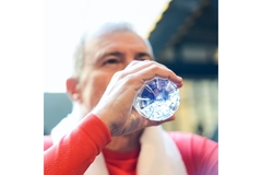 Image man drinking water from a plastic bottle