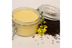 Image Canola seeds and its yellow extract in a glass container.