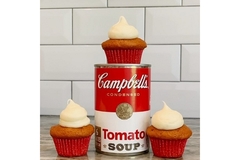 Image A can of tomato soup with cupcakes on top, left and right displayed on a floor.
