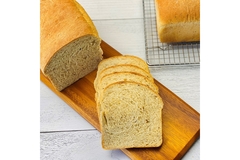 Image Slices of bread on a cutting board.