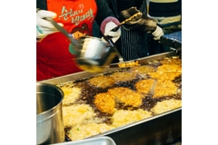 Image foodservice employee deep-frying cutlets