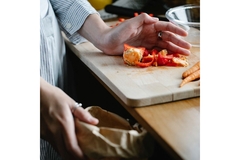 Image Person putting food scraps in the bin.