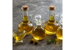 Image Five glass containers filled with olive oil.