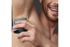 Image A man applies deodorant.