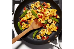 Image Plant based egg dish in a black pan.