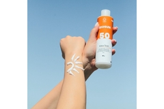 Image An arm with sunscreen on it in the shape of a sun.