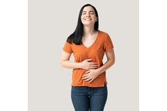 Woman putting hands on her stomach and smiling.