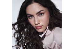 Image A woman with makeup on staring into the camera.