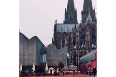 Image Cologne's church and Messe convention center.