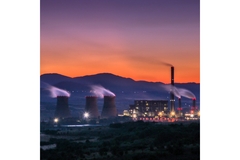 sunset view of a factory with big chimneys