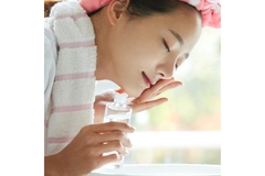 Image A woman washing her face.