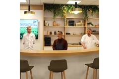 Image Three chefs standing behind kitchen top.