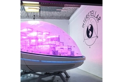 Image An oval enclosed pod held on three legs inside a room.