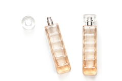 Two perfume bottles next to eachother on a white background.