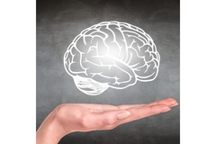 Image Person holds a drawing of a glowing human brain.
