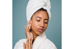 Image Woman wearing bath robe and hair towel posed looking to the right.