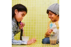 Image Two kids drinking milk.