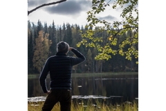 Image Person looking out into Finnish forest.